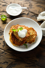 Traditional homemade latkes with sour cream