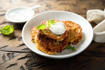Traditional homemade latkes with sour cream