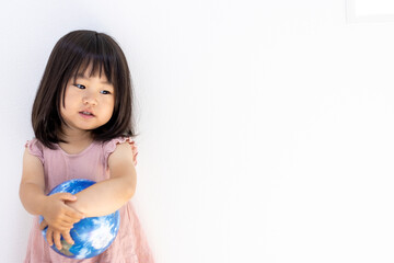 地球儀を持つ落ち込んだ女の子（2歳11か月、日本人）