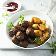 Homemade veal meatballs with potato and berry sauce