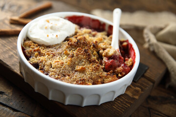 Traditional homemade berry crumble with cream