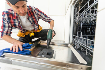 One repairman fixing malfunctioning kitchen dishwasher problem