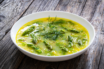 Asparagus soup on wooden table
