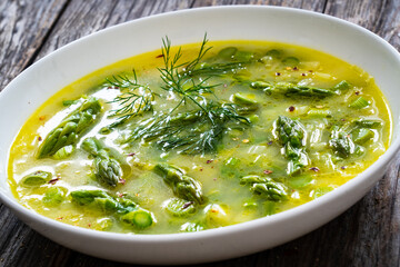 Asparagus soup on wooden table
