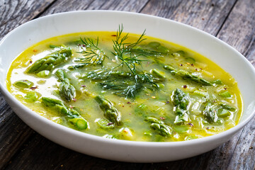 Asparagus soup on wooden table
