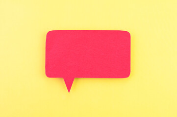 Red speech bubble on yellow background.