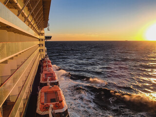 Breathtaking sunrise or sunset over Atlantic Ocean seen from deck of luxury cruiseship cruise ship...