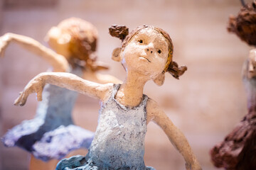 Plaster doll of a ballet girl ,Bokeh light background , home decoration ideas