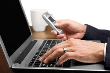Portrait of man hands holding phone and using laptop isolated on white background