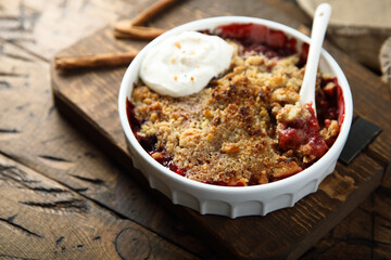 Traditional homemade berry crumble with cream