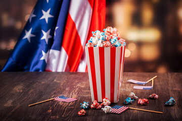 Golden paper cups with red, blue, white popcorn. US colors for 4th july. Snack food for USA independence day celebration
