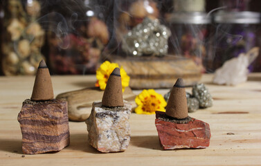Incense Cones and Chakra Stones With Flowers in Background Shallow DOF
