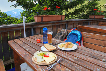 Traditional food on a wooden table on an alm hut in the mountains