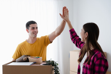 Young man giving high five to girlfriend