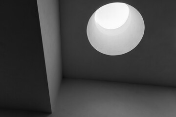 Abstract minimal interior with round skylight portal, black and white