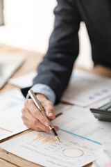 Close up young man with calculator counting making notes at home, hand is writing in a notebook. Savings finances concept