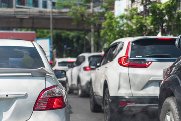 Smoke from city traffic and car emissions pollutes the air. lowering carbon dioxide emissions from vehicle combustion and global warming pollution.