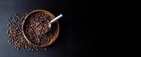 Fotobehang Coffee beans with metal scoop on dark background, top view. Stillife with heap of roasted Arabica grains in wooden bowl, decor for coffee shop. © Repina Valeriya