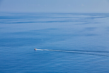 Boat cruising blue Mediterranean sea aerial view