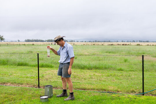 Farmer Checking Rainfall As Rain Storm Finishes