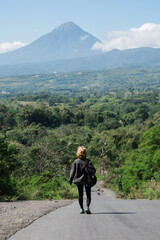 A beautiful, young girl, of European appearance, with blond, curly hair, is traveling with a...