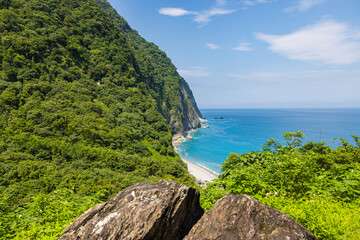 Stunning view reveals the grandeur of the cliffs at Taiwan southeast coast, Qingshui Cliff near Taroko National Park. Towering and lush, they overlook the azure sea, evoking a sense of awe. Landscape