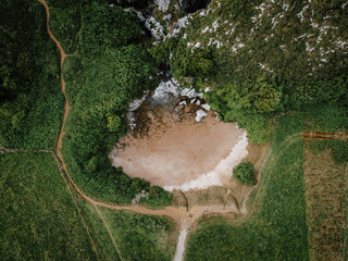 Mountain land beach, drone shot: Majestic mountains frame a serene land beach, creating a breathtaking vista from above.