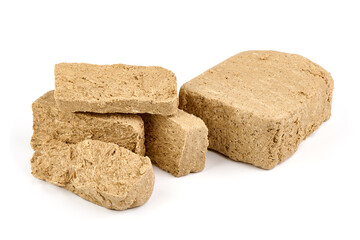 Pieces of sunflower halva, isolated on white background.