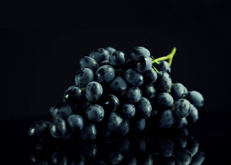 bunch of ripe dark grape isolated on black background