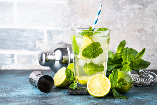 Mojito With Rum, Mint And Lime In Tall Glass. Traditional Summer Drink With Ice.