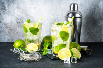 Mojito with rum and lime on black background. Tradition Summer drink with ice.