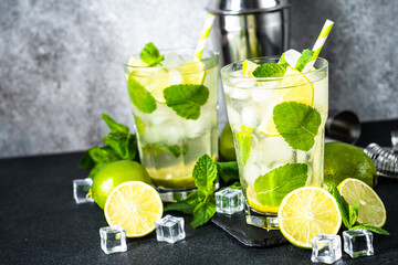 Mojito with rum and lime on black background. Tradition Summer drink with ice.