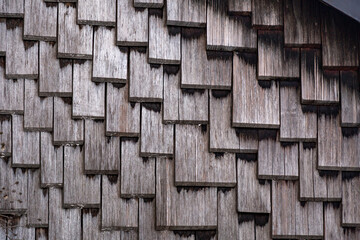 Close up texture background of a wall covered with wooden shingles
