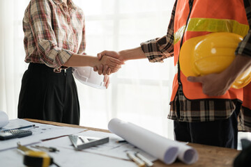 Close-up image of an engineer shaking hands with his coworker during the meeting. teamwork, building trust, unity