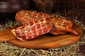 Smoked duck on wooden background