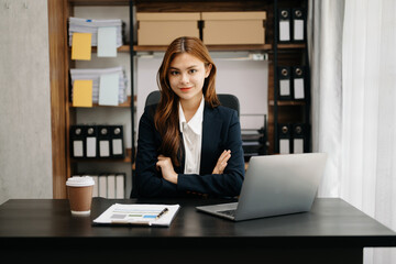 Fototapeta na wymiar Business asian woman using tablet and laptop for doing math finance on an office desk, tax, report, accounting, statistics, and analytical research concept in office