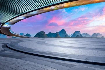 Zelfklevend Fotobehang Guilin Empty square floor and bridge with karst mountain natural scenery at sunrise