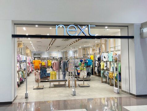 "Next" store in shopping mall. Shop of latest women's, men's, children's fashion clothes, homeware, beauty, designer brands etc. Next plc British multinational clothing, footwear, home products retail