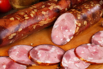 Still life with sausage on a wooden background