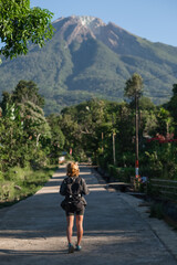 A beautiful, young girl, of European appearance, with blond, curly hair, is traveling with a...