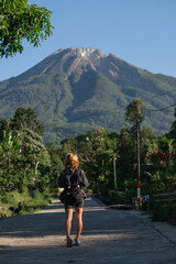 A beautiful, young girl, of European appearance, with blond, curly hair, is traveling with a...