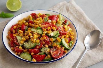 Summer Homemade Corn Salad with Cucumber and Feta, side view.