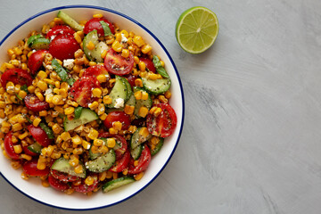 Summer Homemade Corn Salad with Cucumber and Feta, top view. Overhead, from above, flat lay.