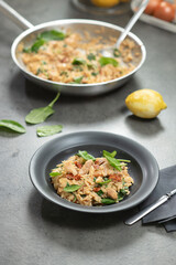 Chicken with orzo pasta, served on a plate.
