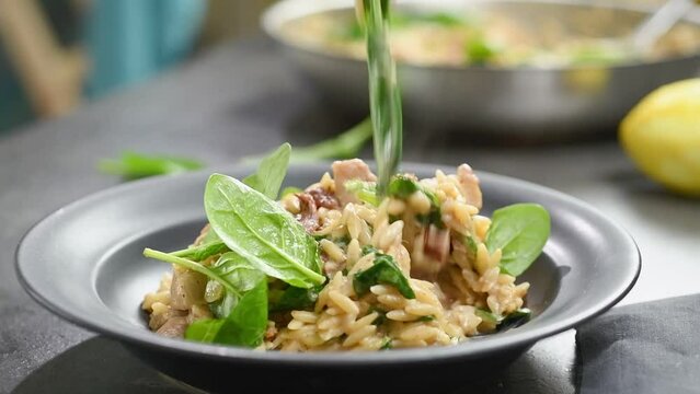 Eating freshly cooked chicken with orzo pasta.
