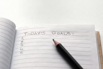 TODAY'S GOALS notepad and black pencil