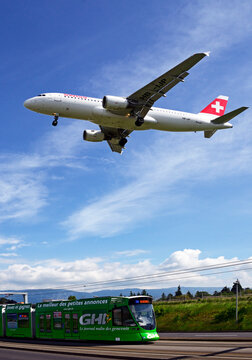 Geneva, Switzerland, Europe - tram on Route de Meyrin near Cointrin Geneva Airport, departing Swiss airline Airbus A-320