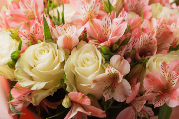 A large bunch of pink alstroemerias and white roses up. Selective focus. The farmer's market.