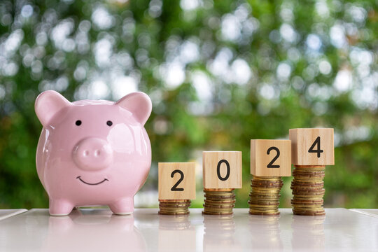 Piggy Bank, Stack of Coins and New Year 2024 - home finance concept