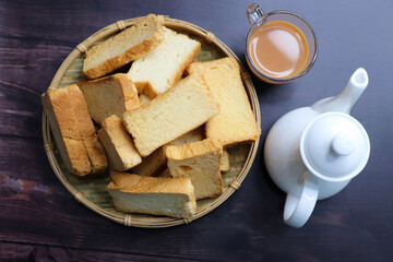 Tea Time Snack. Healthy Wheat rusk served with Indian hot masala tea and milk jug over black...